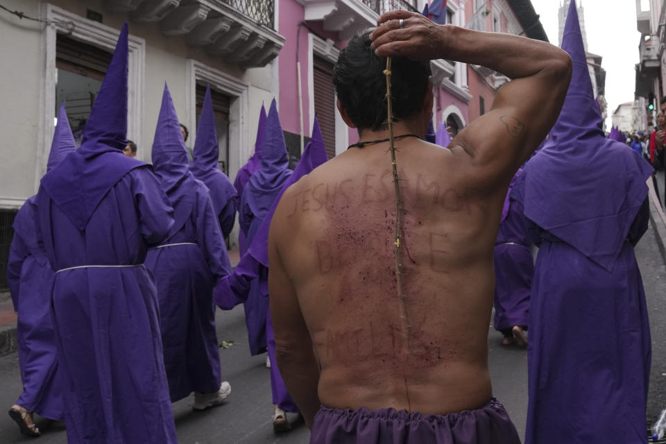 A penitent flogs his back as he takes part in the Jesus the Almighty Good Friday procession, as part of Holy Week celebrations, in Quito, Ecuador, Friday, March 29, 2024. Holy Week commemorates the last week of Jesus Christ’s earthly life which culminates with his crucifixion on Good Friday and his resurrection on Easter Sunday. (AP Photo/Dolores Ochoa)