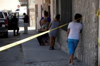Relatives react near a crime scene where unknown assailants murdered a member of the LGBT community, in Ciudad Juarez