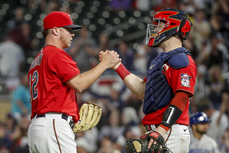 Minnesota Twins relief pitcher Emilio Pagan, left, celebrates with catcher Ryan Jeffers after the team's victory over the Kansas City Royals in a baseball game Friday, May 27, 2022, in Minneapolis. (AP Photo/Bruce Kluckhohn)