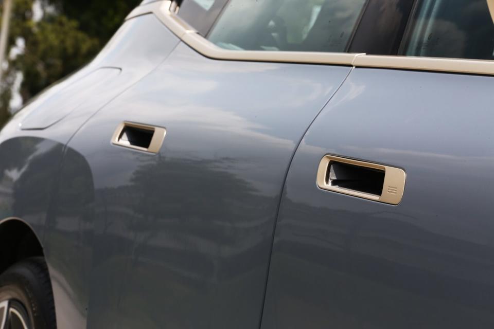 車門把手採用內嵌式設計，就連整合感應門鎖功能的銅色外框都貼合於車身線條之內。