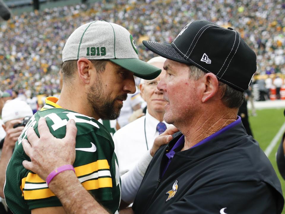 Minnesota Vikings head coach Mike Zimmer talks to Green Bay Packers' Aaron Rodgers after an NFL football game Sunday, Sept. 15, 2019, in Green Bay, Wis. The Packers won 21-16. (AP Photo/Matt Ludtke)