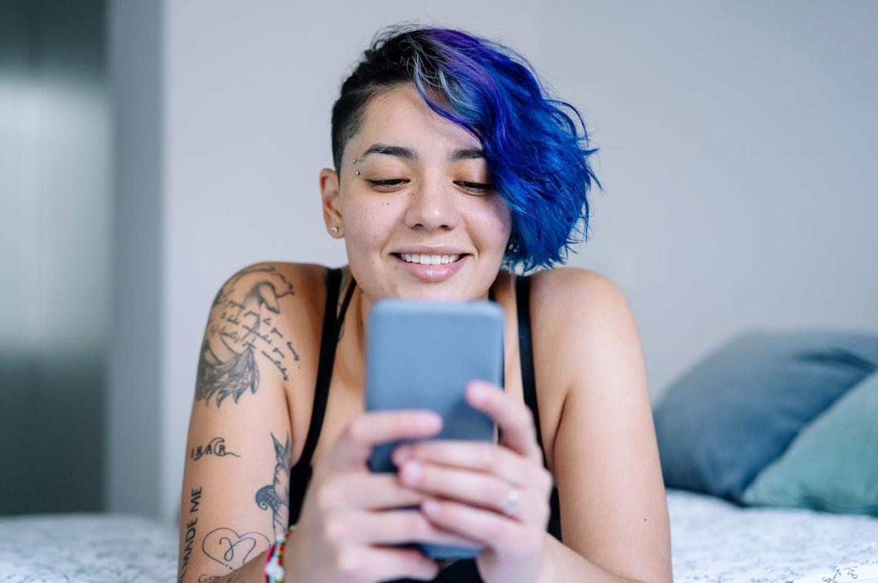 Feeling generous? <a href="https://www.gettyimages.com/detail/photo/hispanic-tattoo-woman-with-smartphone-in-bedroom-royalty-free-image/1443546298?adppopup=true" rel="nofollow noopener" target="_blank" data-ylk="slk:Vera Vita/Moment via Getty Images;elm:context_link;itc:0;sec:content-canvas" class="link ">Vera Vita/Moment via Getty Images</a>