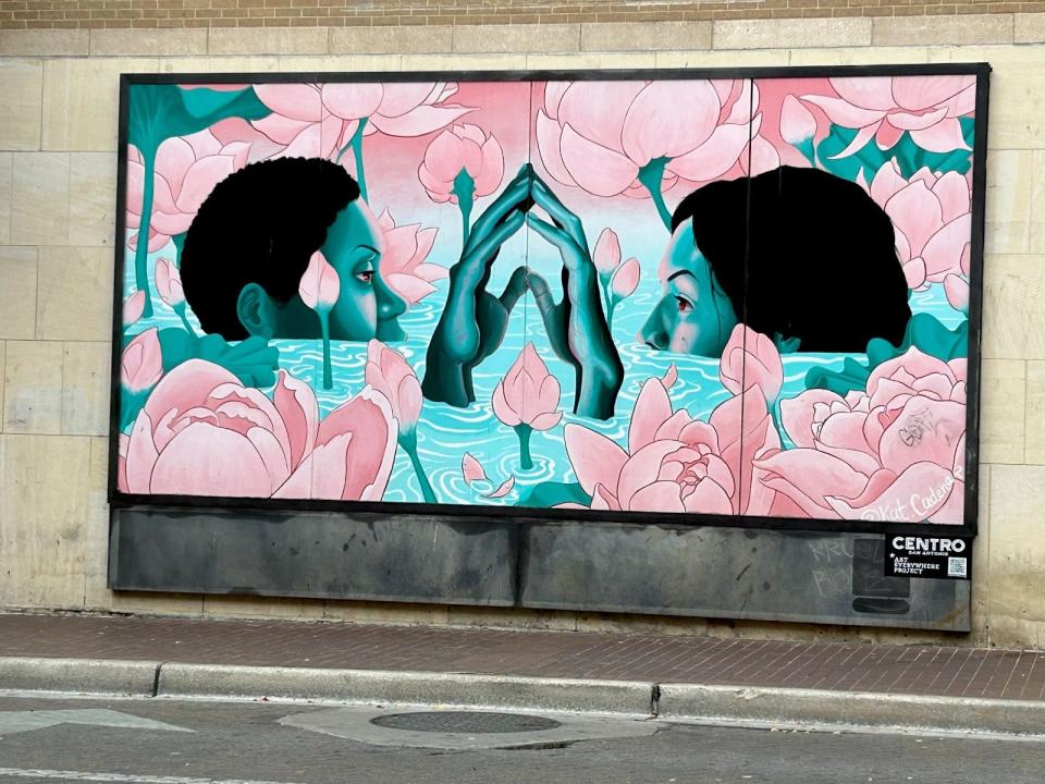 mural in san antonio of two people touching fingertips