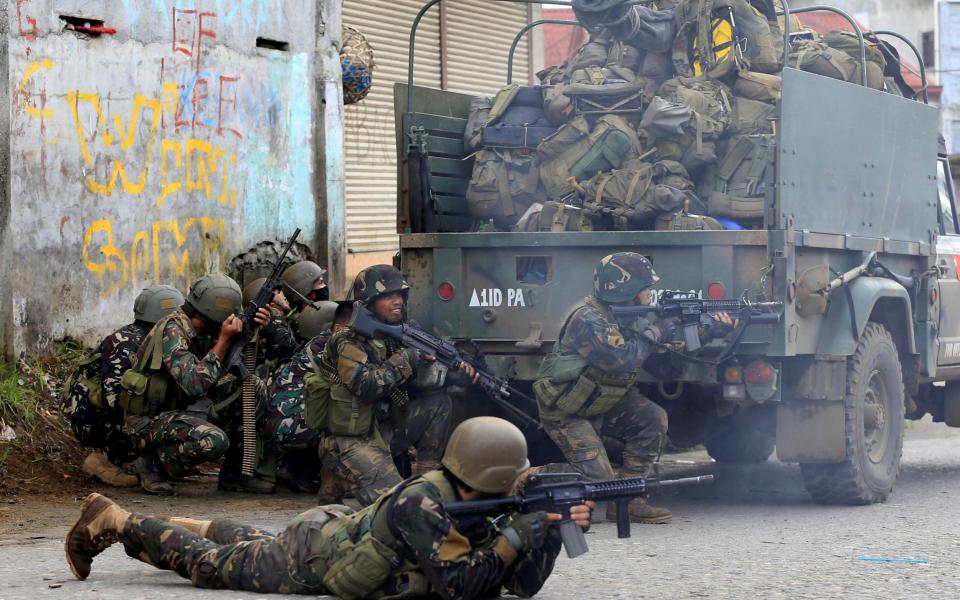 Government troops are seen during an assault on insurgents from the so-called Maute group, who have taken over large parts of Marawi City - Credit: ROMEO RANOCO/ REUTERS