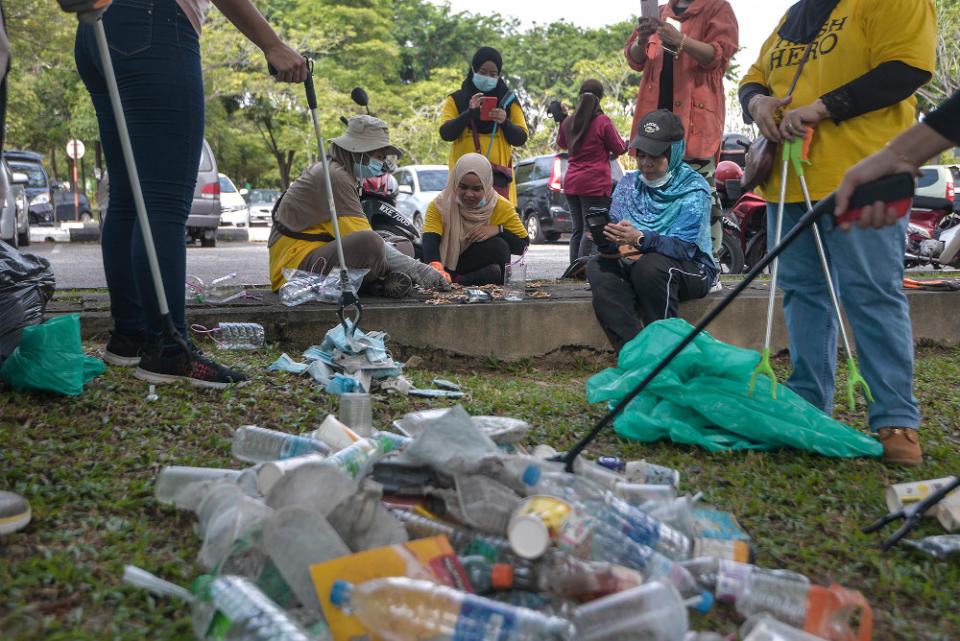 Trash Hero Putrajaya volunteers conducting a trash audit after the clean-up. — Picture by Shafwan Zaidon