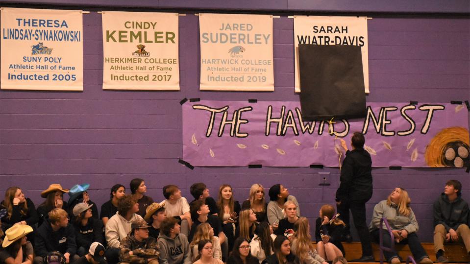 West Canada Valley athhletic director Todd Hobin unveiled the newest banner on the wall of the school's gym during halftime of the boys' basketball turnament game against Mt. Markham Wednesday. Sarah Wiatr set 10 school records in indoor and outdoor track and field at West Canada Valley.