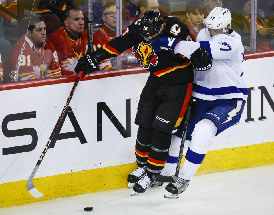 Tampa Bay Lightning defenseman Victor Hedman, right, checks Calgary Flames forward Jonathan Huberdeau during the third period of an NHL hockey game in Calgary, Alberta, Saturday, Jan. 21, 2023. (Jeff McIntosh/The Canadian Press via AP)