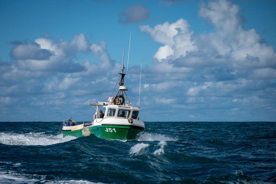 Fishermen process their catch of lobster and crab on the deck of their boats, while fishing off the coast of Jersey (Ben Birchall/PA) (PA Wire)