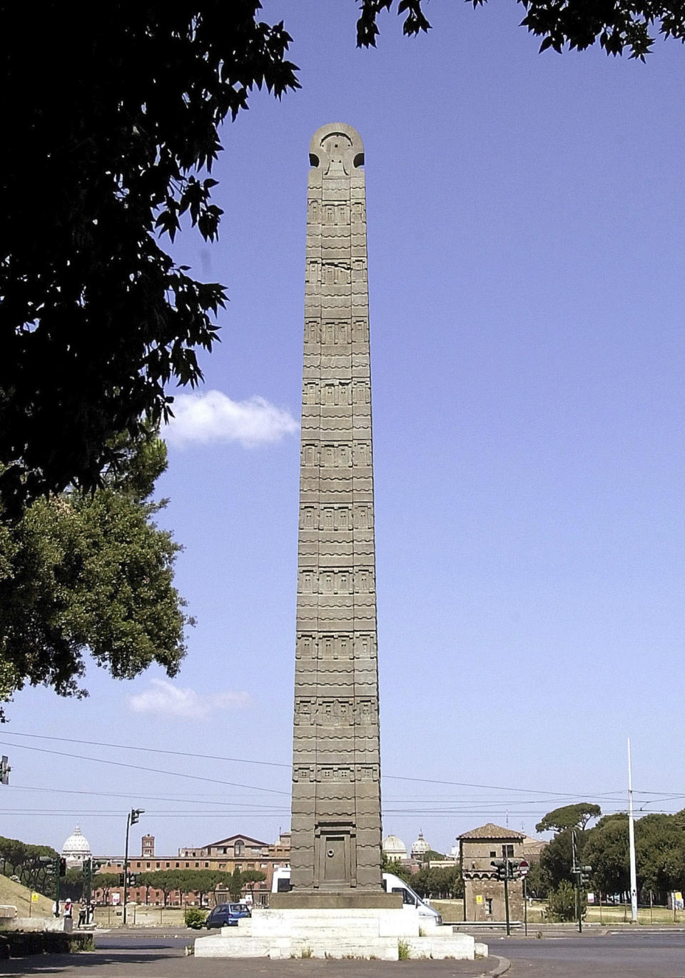 FILE - The 1,000-year-old obelisk of Axum, which was brought to Italy after Fascist dictator Benito Mussolini's 1937 invasion of Ethiopia, stands upright in the heart of downtown Rome, Saturday, July 21, 2001. Italy, a long time victim of antiquities theft that has worked for decades to recover its treasures, is coming to terms with the fact that it, too has stolen loot in its museum collections: the relics of a brutal colonial empire that the country hasn't fully reckoned with. (AP Photo/Plinio Lepri, File)