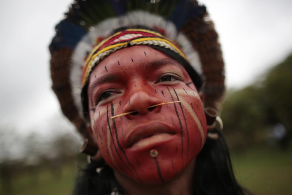 An Indigenous Indian dances at the Esplanade of Ministries during a demonstration against the PEC 215 in Brasilia