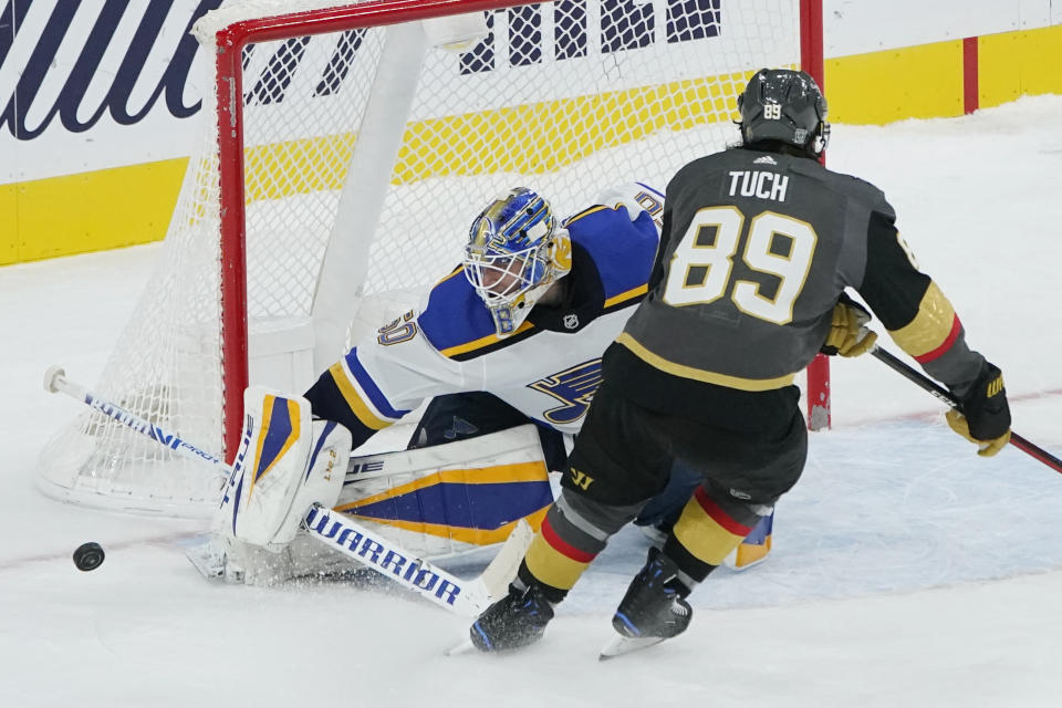 St. Louis Blues goaltender Jordan Binnington (50) blocks a shot by Vegas Golden Knights right wing Alex Tuch (89) in the shootout of an NHL hockey game Tuesday, Jan. 26, 2021, in Las Vegas. (AP Photo/John Locher)