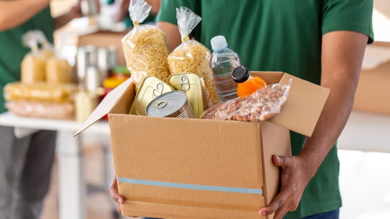 man carrying donated food box