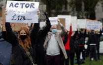 Actors and performers protest against coronavirus restrictions as part of a week of protests in Parliament Square in London, Thursday, Oct. 29, 2020. The British government is under pressure to develop a national strategy to combat the resurgence of the COVID-19 pandemic and “rescue Christmas’’ as scientists warn that the number of people hospitalized with the disease could almost triple by the end of next month unless something more is done now. (AP Photo/Frank Augstein)