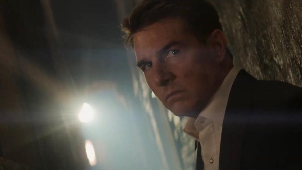 Tom Cruise's Ethan Hunt looks angry back lit in an alley in Mission: Impossible - Dead Reckoning Part One