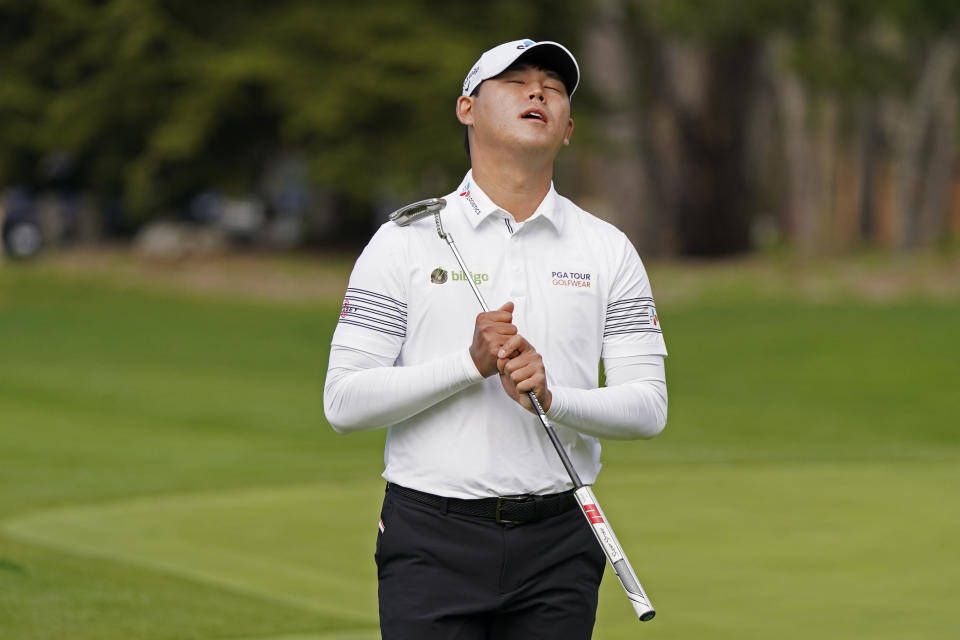 Si Woo Kim, of South Korea, reacts after missing a birdie putt on the sixth green of the Spyglass Hill Golf Course during the second round of the AT&T Pebble Beach Pro-Am golf tournament Friday, Feb. 12, 2021, in Pebble Beach, Calif. (AP Photo/Eric Risberg)