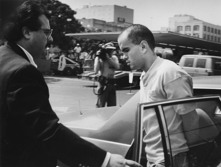 Los Angeles- LAPD officials escort Robert Bardo into the rear entranceof Parker Center August 10, 1989.