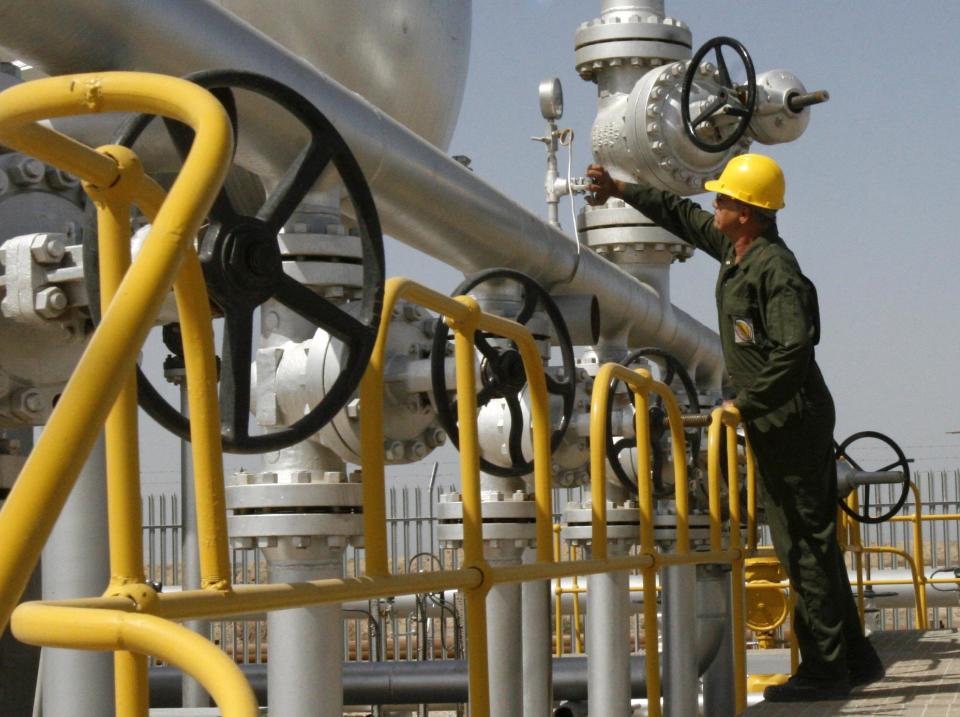 FILE- In this Tuesday, April 15, 2008 file photo, Iranian oil technician Majid Afshari checks the oil separator facilities in Azadegan oil field, near Ahvaz, Iran. When Iran welcomes leaders to a world gathering next week, few will get a grander reception than India's prime minister. As Tehran tries to offset the squeeze from Western oil sanctions, there is no greater priority than courting energy-hungry Asian markets. (AP Photo/Vahid Salemi, File)