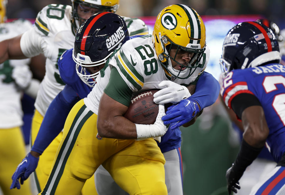 Green Bay Packers running back AJ Dillon (28) carries the ball against the New York Giants during the second quarter of an NFL football game, Monday, Dec. 11, 2023, in East Rutherford, N.J. (AP Photo/Adam Hunger)