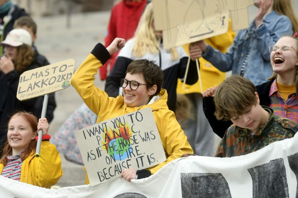 Young climate activists demonstrate in front of the Finnish Parliament building in Helsinki, Finland, Friday May 24, 2019, a global day of student protests aiming to spark world leaders into action on climate change. (Vesa Moilanen/Lehtikuva via AP)