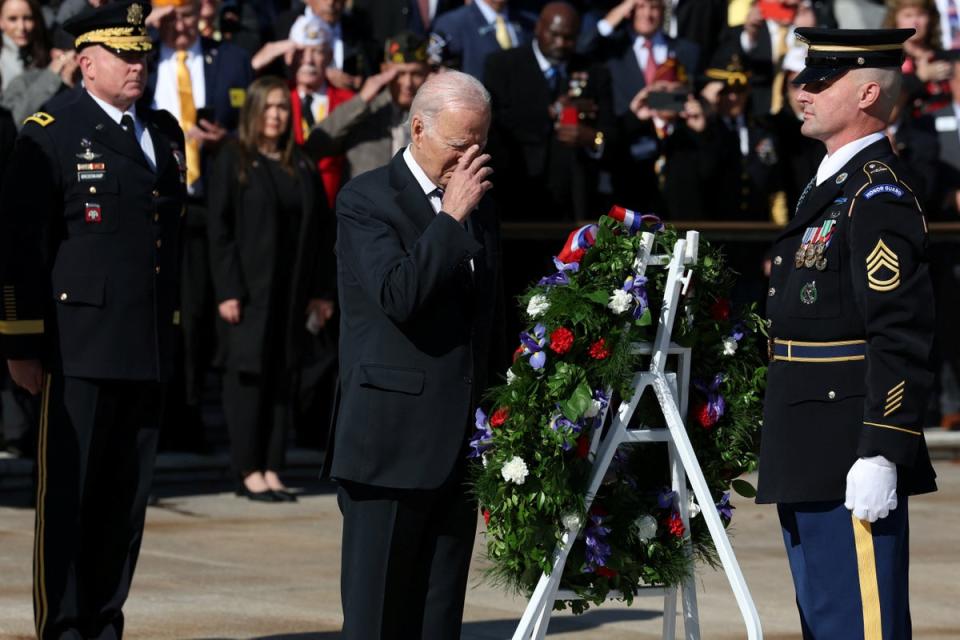 US President Joe Biden places a wreath while hosting veterans and members of the military community during a Veterans Day observance at the White House in Washington DC on 11 November (REUTERS)