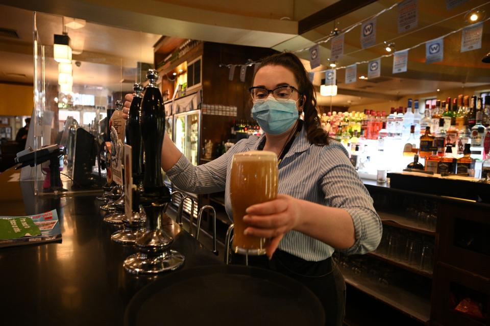 A member of the bar staff pulls a pint in a Wetherspoons pub in Leigh, Greater Manchester