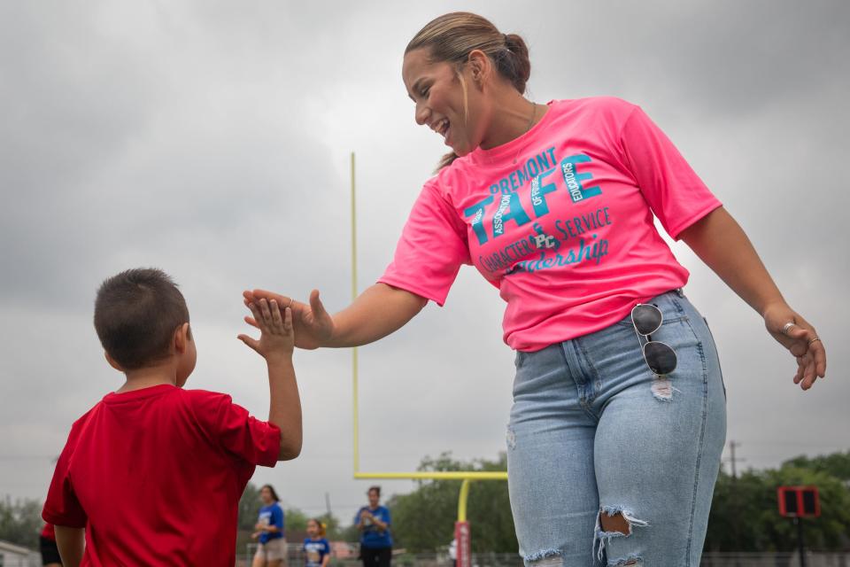 Premont Early College High School student Dayna Davila high-fives Special Olympics competitor Angel Silguero after he completes a bean bag toss on Wednesday, May 1, 2024, in Premont, Texas. Davila is part of the Rural Schools Innovation Zone Grow Your Own Educator Academy.