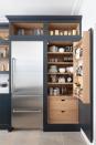 <p>Here, a smart navy grey pull-out larder-style cabinet helps to provide extra storage space in a small kitchen. The shelves above are excellent for placing standout accessories, and the fridge next door means you've got everything you need in one practical place. </p><p><strong>READ MORE:</strong> <a href="https://www.housebeautiful.com/uk/decorate/kitchen/a23569477/kitchen-colour-ideas/" rel="nofollow noopener" target="_blank" data-ylk="slk:7 kitchen colour ideas;elm:context_link;itc:0;sec:content-canvas" class="link ">7 kitchen colour ideas</a></p><p>• Shop the look at <a href="https://www.tomhowley.co.uk/?key=848448&campaign=1WG-KB&date=03-19&gclid=CjwKCAjw7MzkBRAGEiwAkOXexK6LvmOLGblHjEV4XCZcNgeesrwosCtSZQGLWji7xGvp8IxK3G5b0RoC9XEQAvD_BwE&gclsrc=aw.ds" rel="nofollow noopener" target="_blank" data-ylk="slk:Tom Howley;elm:context_link;itc:0;sec:content-canvas" class="link ">Tom Howley</a></p>