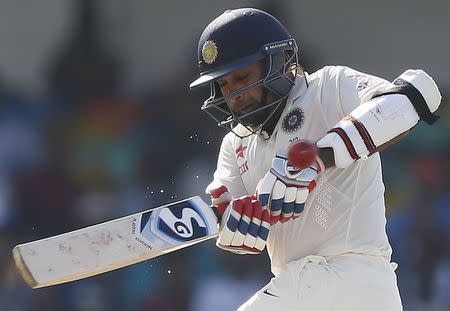 India's Amit Mishra hits a boundary during the second day of their third and final test cricket match against Sri Lanka in Colombo , August 29, 2015. REUTERS/Dinuka Liyanawatte