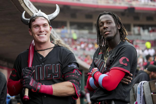 Cincinnati Reds' Spencer Steer (7) places a viking helmet on the head of  Elly De La Cruz (44) after Cruz hit a home run during the second inning of  a baseball game