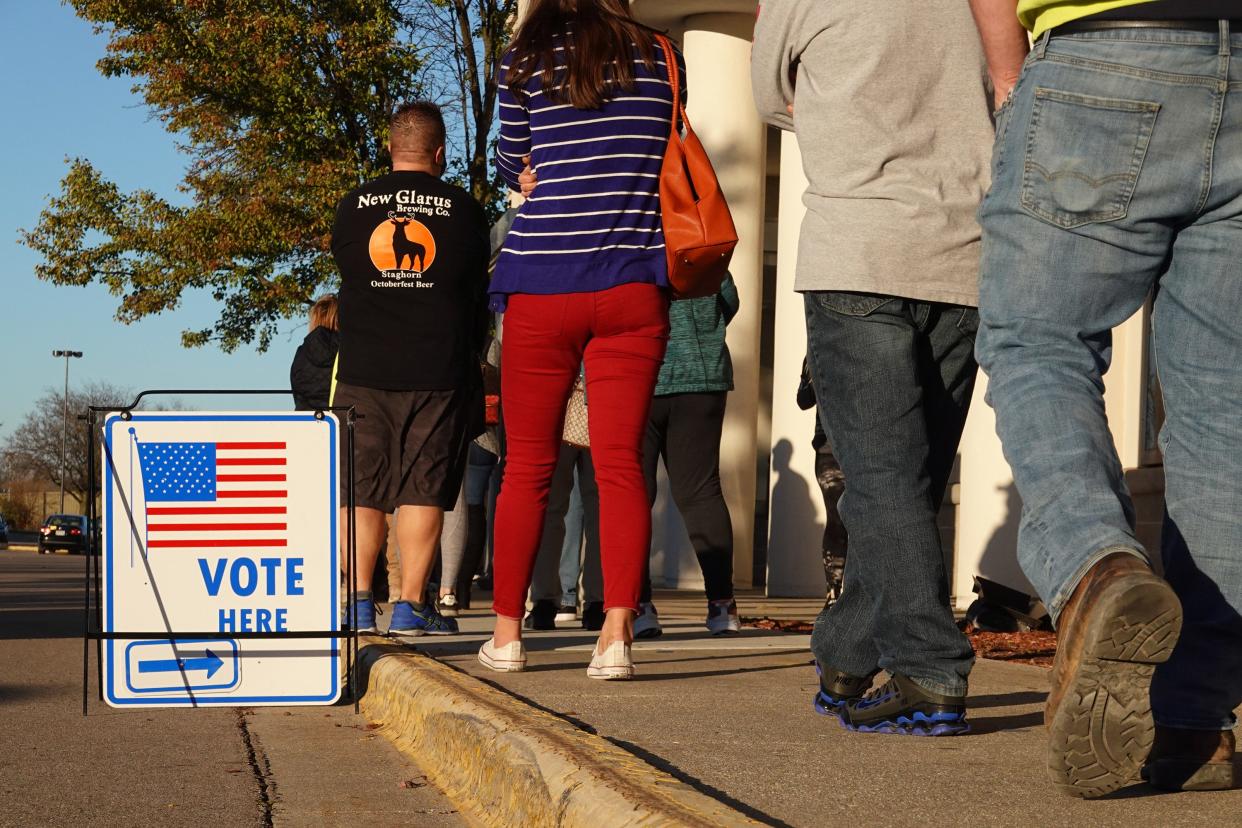 Residents wait in line to vote at a shuttered Sears store in the Janesville Mall on November 03, 2020 in Janesville, Wisconsin.