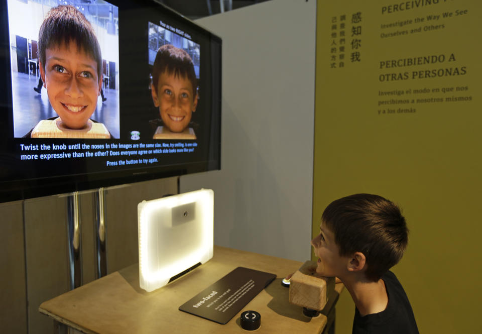 Zachary Scholnick, 9, of Petaluma, Calif., plays with an exhibit about perceiving people at the Exploratorium, an interactive science and activities museum, during a preview in San Francisco, Tuesday, April 9, 2013. The new $300 million museum is set to open April 17 at its new location along the bay with more space and new exhibits. The 330,000-square-foot museum at Pier 15 along the Embarcadero has three times more space than the previous location at the Palace of Fine Arts in the city's Marina neighborhood. (AP Photo/Eric Risberg)