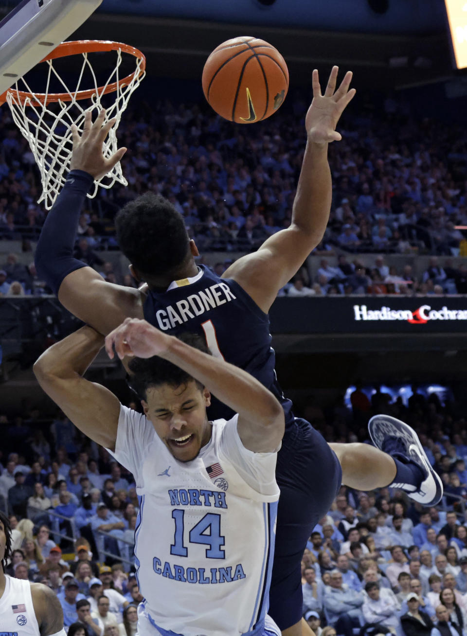 North Carolina forward Puff Johnson (14) and Virginia forward Jayden Gardner (1) collide during the second half of an NCAA college basketball game Saturday, Feb. 25, 2023, in Chapel Hill, N.C. (AP Photo/Chris Seward)