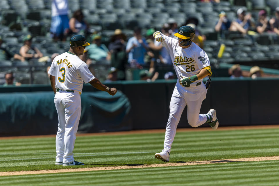 Oakland Athletics' Tyler Nevin (26) is congratulated by third base coach Eric Martins (3) as he runs the bases after hitting a solo home run against the Baltimore Orioles during the fourth inning of a baseball game Saturday, July 6, 2024, in Oakland, Calif. (AP Photo/John Hefti)