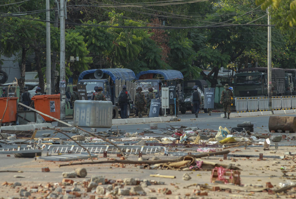 Policemen and soldiers leave after vandalizing makeshift barricades made by anti-coup protesters in Yangon, Myanmar Thursday, March 11, 2021. Amnesty International accused Myanmar's military government on Thursday of increasingly using battlefield weapons against peaceful protesters and conducting systematic, deliberate killings. (AP Photo)