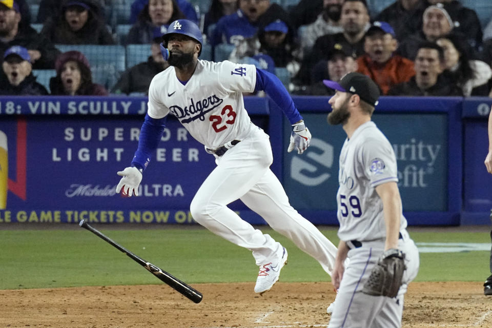 Los Angeles Dodgers' Jason Heyward, left, runs to first after hitting a two-run home run as Colorado Rockies relief pitcher Jake Bird watches during the fifth inning of a baseball game Monday, April 3, 2023, in Los Angeles. (AP Photo/Mark J. Terrill)