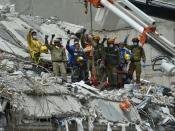 Rescuers call for silence during the search for survivors in a flattened building in Mexico City