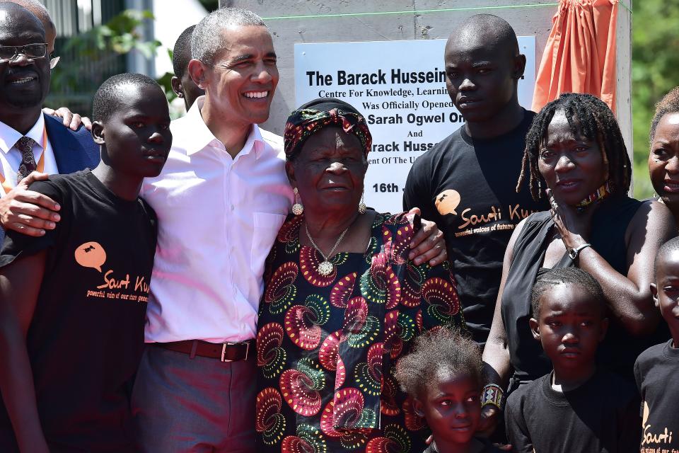 <p>Former US President, Barak Obama (3L) poses for a picrure with his step-grandmother Sarah (C) and half-sister, Auma (2R) and some of the local youth on July 16, 2018 during the opening of the Sauti Kuu Resource Centre, founded by his half-sister, Auma Obama at Kogelo in Siaya county, western Kenya. – Obama is in the east african nation for the first time since he left the US presidency and met with President Uhuru Kenyatta and opposition leader Raila Odinga in Nairobi.(Photo: Tony Karumba/AFP/Getty Images) </p>