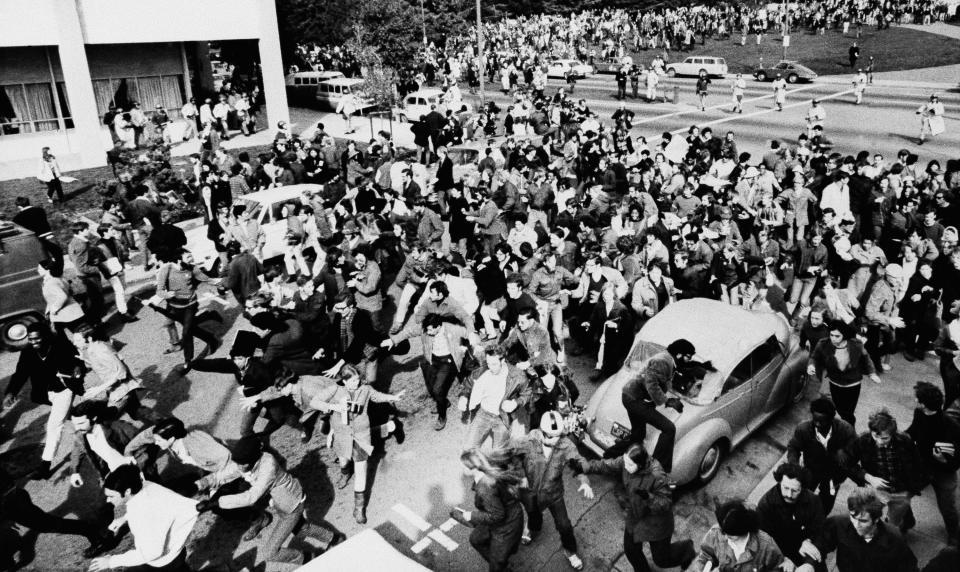 Demonstrators on run - as police (top right and left) move in, student strikers and supporters start to run after trying to disturb a meeting of the university of California regents in the building at left. There were no arrests, but it was the third consecutive day of disturbances at the Berkeley school on Feb. 20, 1969.
