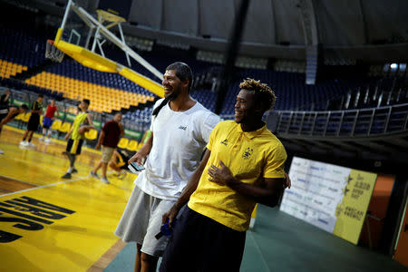 Congolese basketball player Christ Wamba and former Greek basketball national team player and founder of the Athlenda start-up, Lazaros Papadopoulos laugh following a friendly game at the Alexandreio Melathron Nick Galis Hall in Thessaloniki, Greece, September 12, 2018. REUTERS/Alkis Konstantinidis