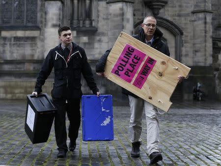 Ballot boxes are carried across West Parliament Square in Edinburgh Scotland, Britain May 6, 2015. REUTERS/Russell Cheyne