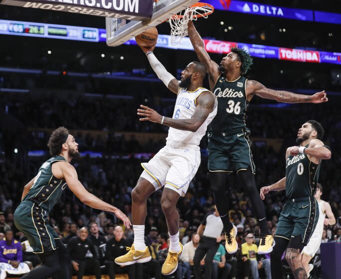 Los Angeles, CA, Tuesday, December 13, 2022 - Los Angeles Lakers forward LeBron James (6) is challenged by Boston Celtics guard Marcus Smart (36) in the first half at Crypto.Com Arena. (Robert Gauthier/Los Angeles Times)