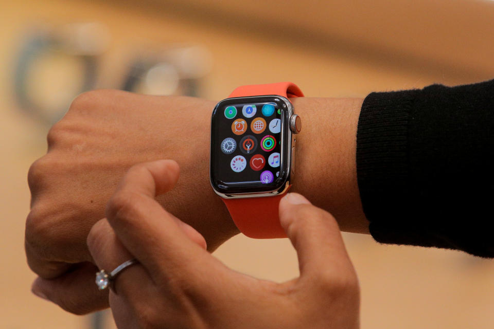 An Apple Store employee shows the new Series 5 Apple Watch during the preview of the redesigned and reimagined Apple Fifth Avenue store in New York, U.S., September 19, 2019. REUTERS/Brendan McDermid