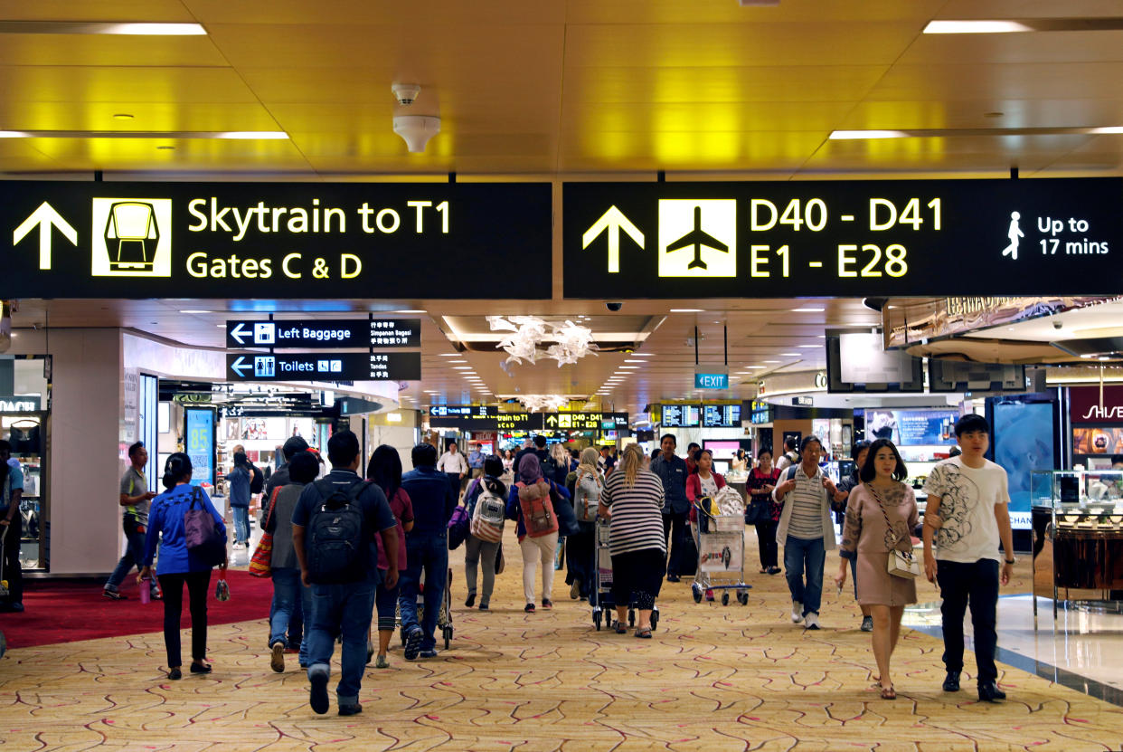 People walk by at the transit area of Changi Airport’s Terminal Two in Singapore October 4, 2017. REUTERS/Edgar Su