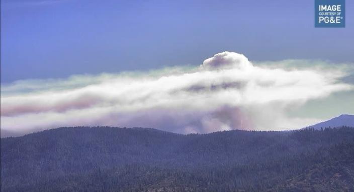 Smoke rises from hills as the Washburn Fire burns near Ahwahnee, California