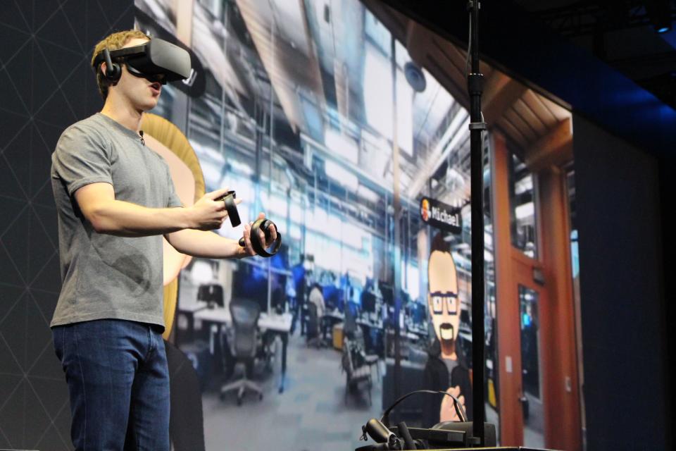 Facebook co-founder and chief executive, Mark Zuckerberg, speaks at an Oculus developers conference while wearing a virtual reality headset in San Jose, California on October 6, 2016. 
Facebook unveiled new hardware for its Oculus division as part of a stepped-up effort to integrate virtual reality with the leading social network. The new offerings aim to get an array of virtual reality gear to consumers in the coming months, including a new 