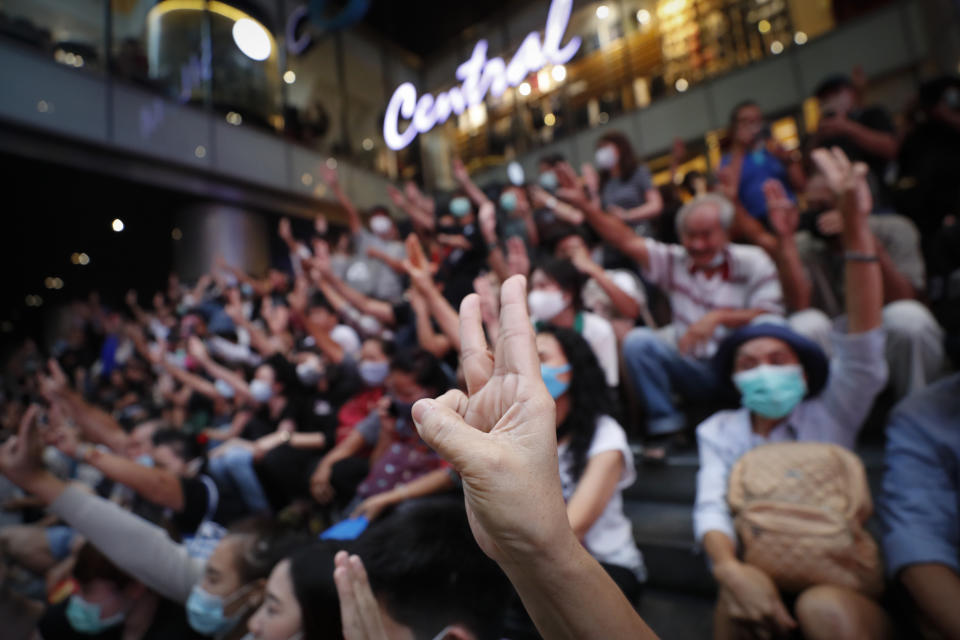 Pro-democracy demonstrators flash a three-finger salute of defiance during a protest rally at the Silom business district in Bangkok, Thailand, Thursday, Oct. 29, 2020. The protesters continue to gather Thursday with their three main demands of Prime Minister Prayuth Chan-ocha's resignation, changes to a constitution that was drafted under military rule and reforms to the constitutional monarchy. (AP Photo/Sakchai Lalit)