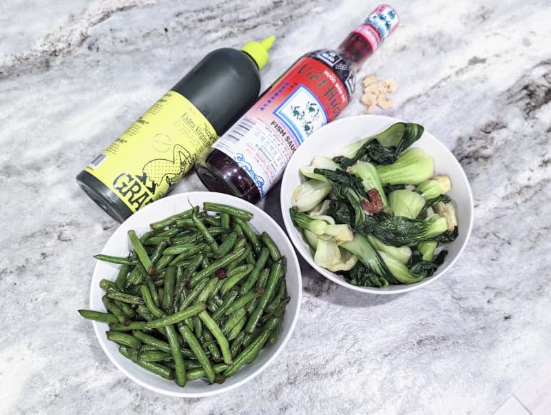 Seasoned vegies near seasoning bottles.