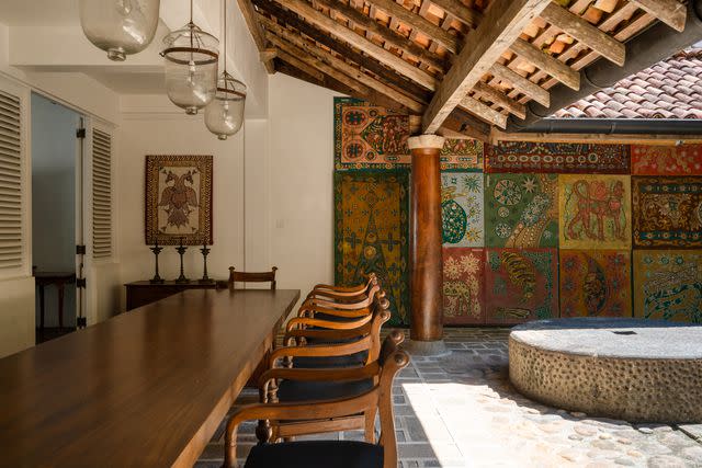 <p>Courtesy of Teardrop Hotels</p> A courtyard at the Ena de Silva house, decorated with the artistâ€™s colorful batik panels.