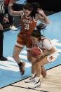 Maryland's Katie Benzan saves a ball in front of Texas's Audrey Warren during the first half of an NCAA college basketball game in the Sweet 16 round of the Women's NCAA tournament Sunday, March 28, 2021, at the Alamodome in San Antonio. (AP Photo/Morry Gash)