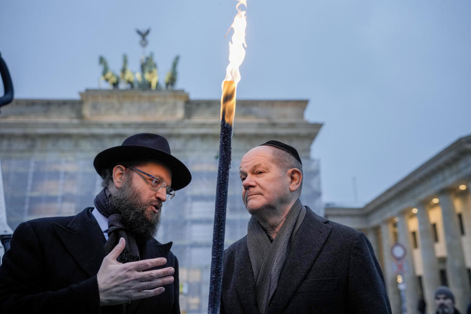 German Chancellor Olaf Scholz, right, and Rabbi Yehuda Teichtal attend the ceremony to light the first candle of Hanukkah menorah at Brandenburg Gate in Berlin, Germany, Thursday, Dec. 7, 2023. (AP Photo/Markus Schreiber)